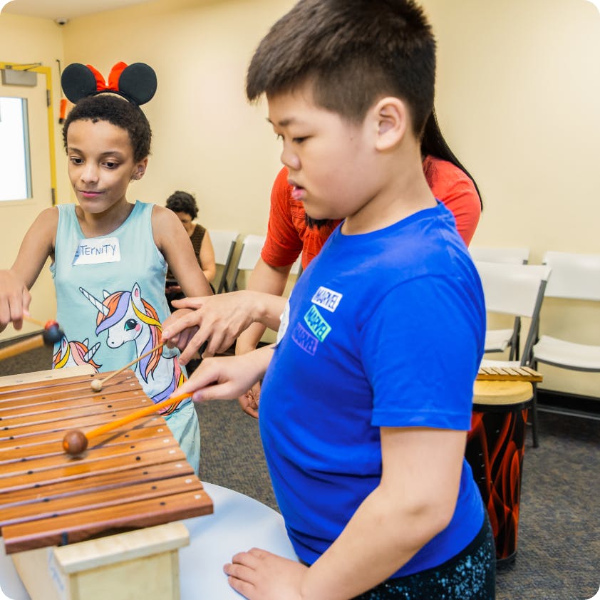 2 DMF participants play the xylophone together
