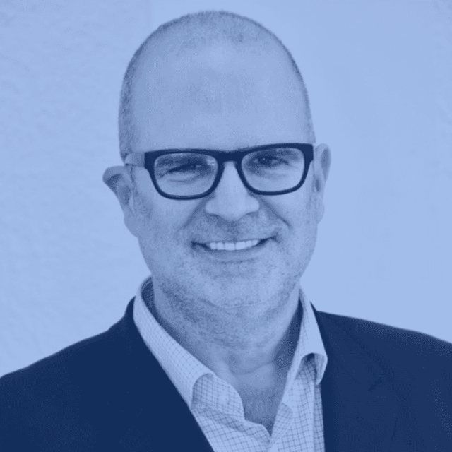 Photo of a smiling middle-aged bald man with rectangular-framed glasses