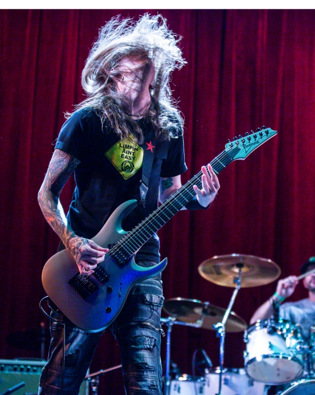 Brandon Mendenhall, guitarist and songwriter for the the Danny Award-receiving group The Mendenhall Experiment, rocks out on a guitar on stage