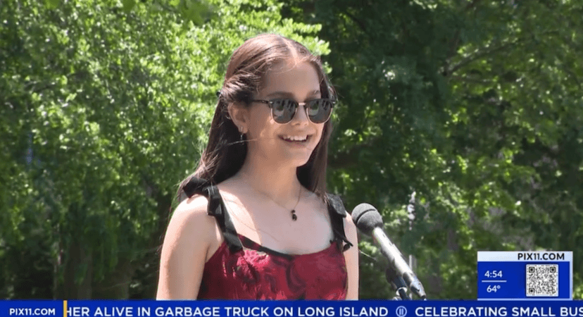 Photo of Iolanta in front of a microphone in Washington Square Park