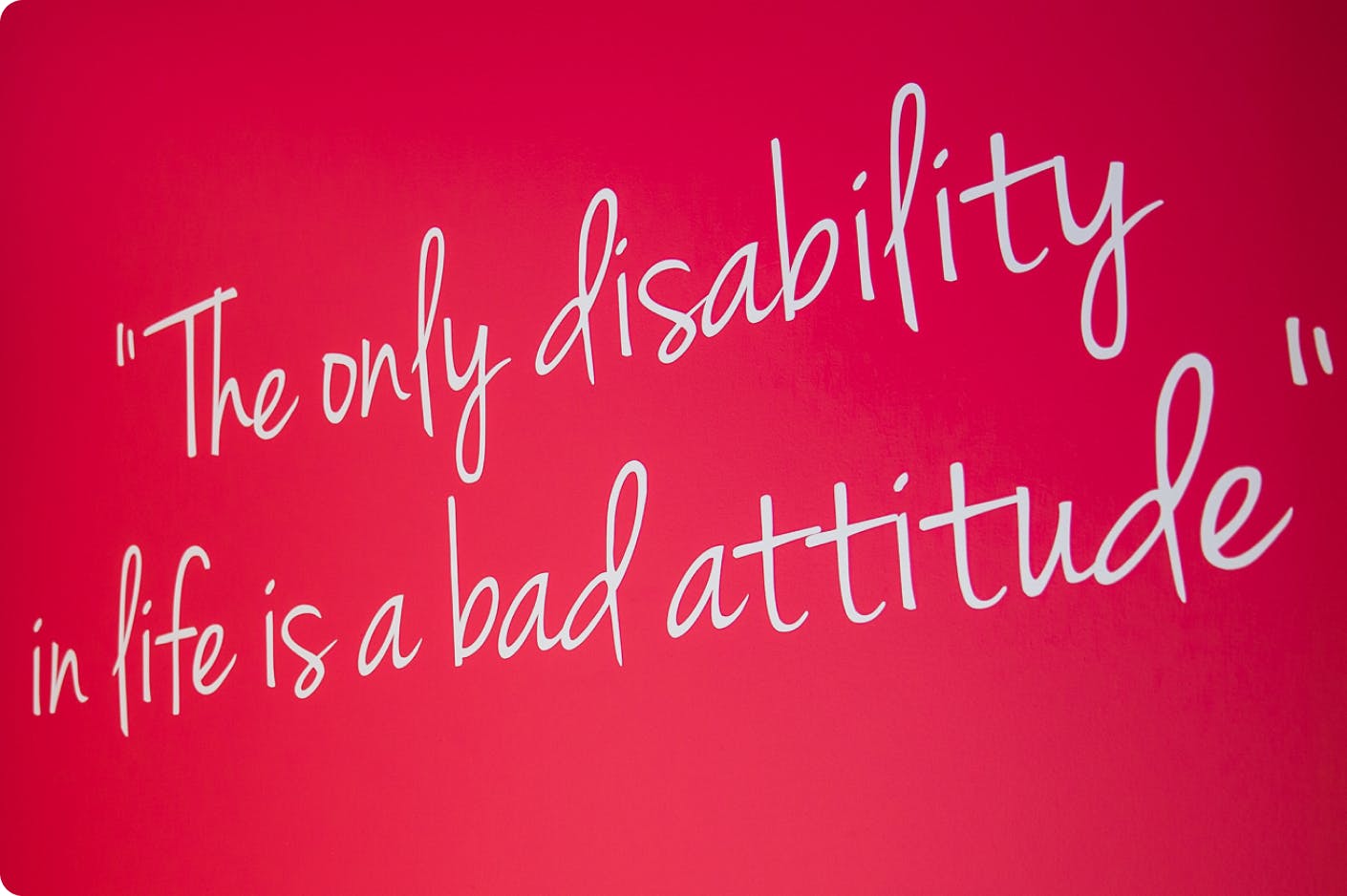 Quote on wall in DMF center that reads "The only disability in life is a bad attitude" 