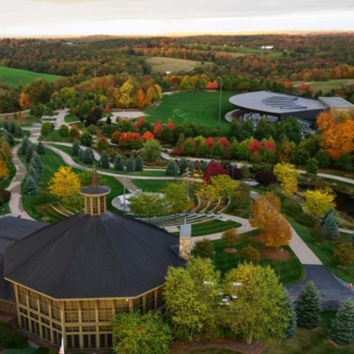 Drone shot of Bethel woods, featuring the museum, the stage, and lots of woodland in the distance. 