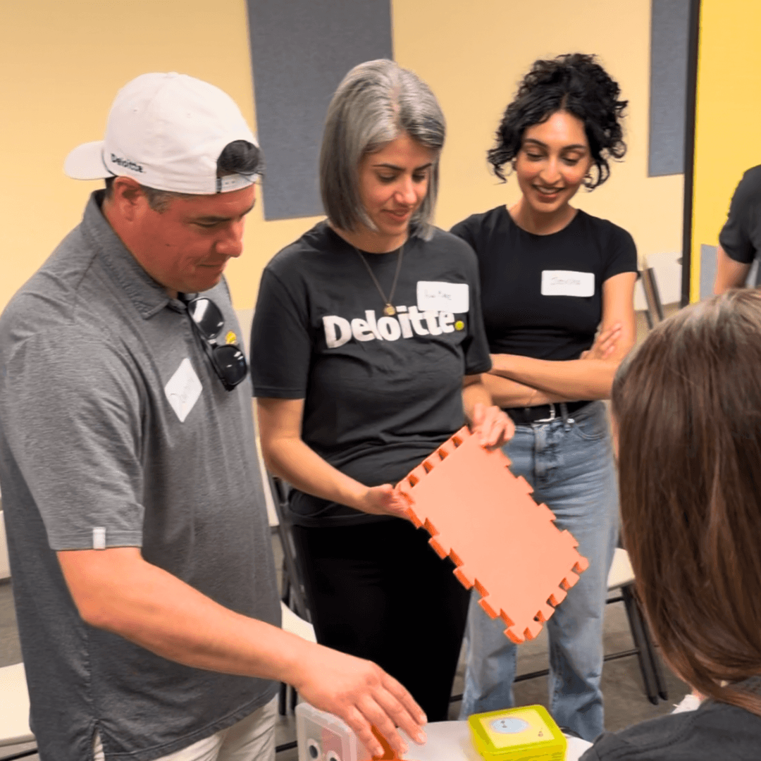 Photo of Deloitte staff visiting the music center and playing with accessible instruments