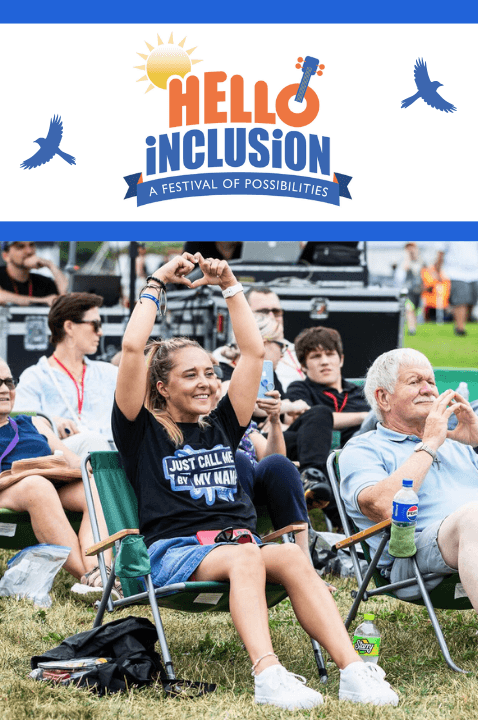 Photo of several people smiling and clapping at an outside festival while sitting on beach chairs. Above them is the Hello Inclusion logo