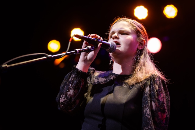 Performer singing into a microphone