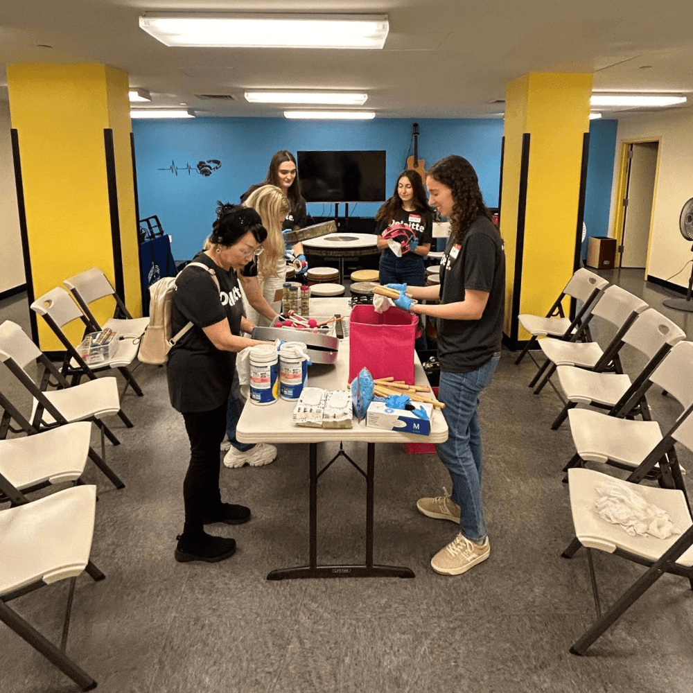 Deloitte volunteers sorting cleaning equipment