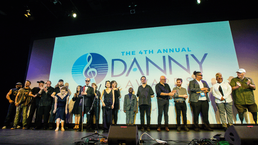 Photo featuring all of the winners of the 2023 Danny Awards standing on stage