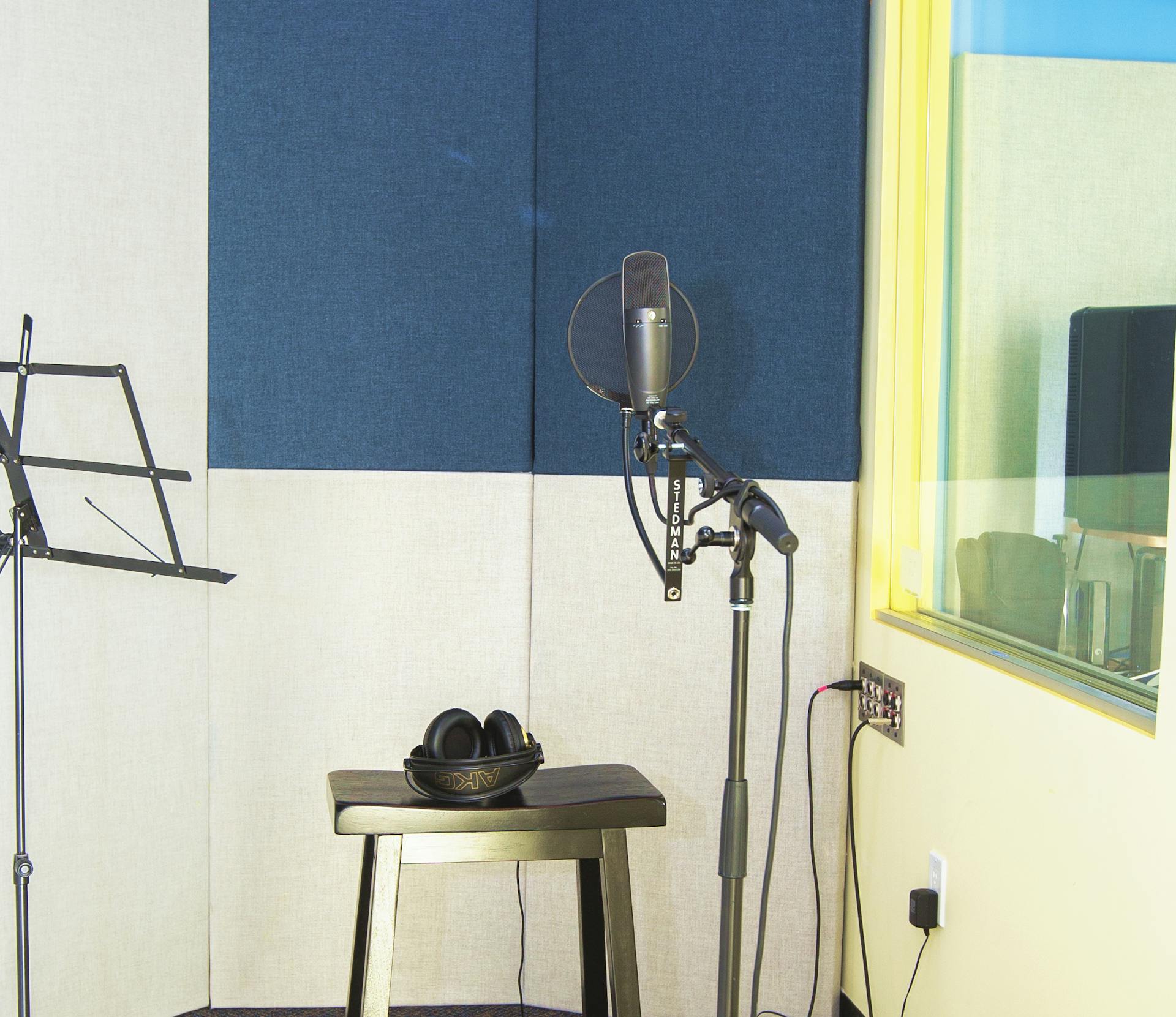 DMF's sound booth with a mic stand next to a stool with headphones on top