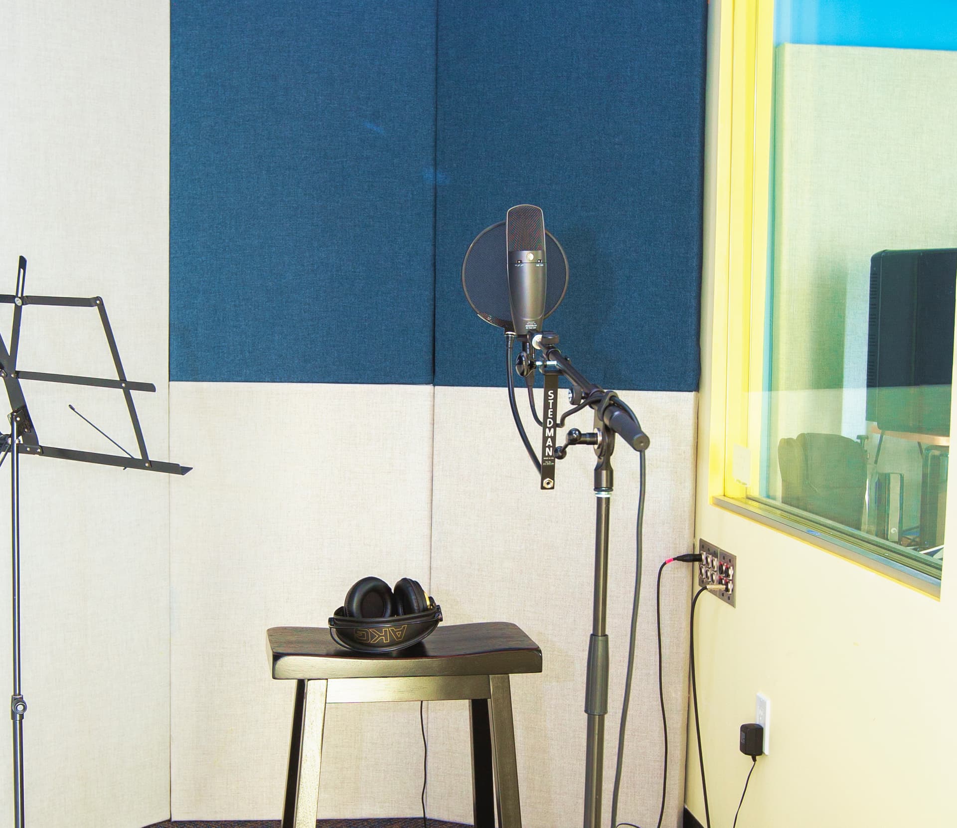 DMF's sound booth with a mic stand next to a stool with headphones on top