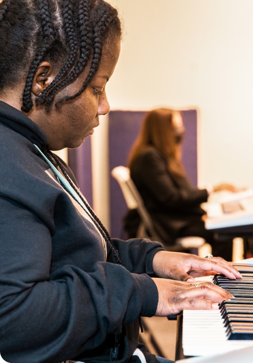 A DMF participant plays the piano