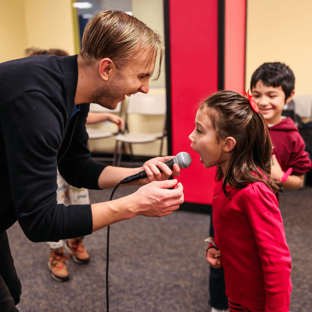 Scott holding microphone for young member