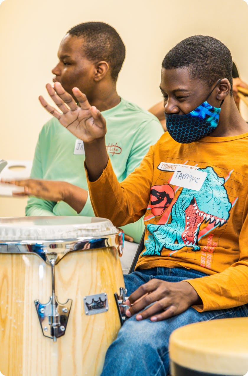 2 DMF participants play drums with their hands